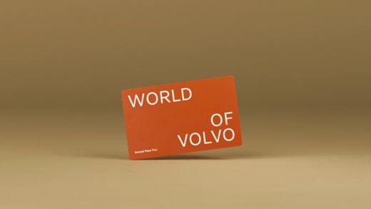 Orange plastic World of Volvo card on an orange background.