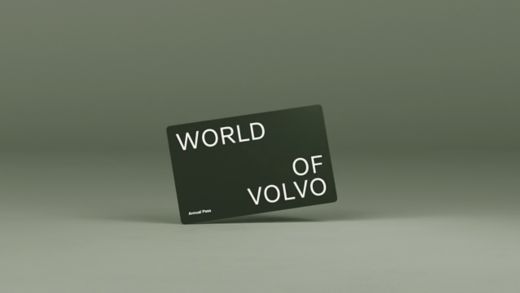 Grey plastic World of Volvo card on an grey background.