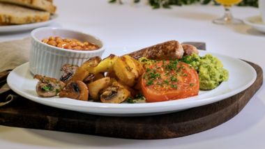 Vegetarian breakfast with roasted potatoes, mushrooms, grilled tomato and beans