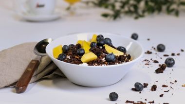 Granola with blueberries and mango pieces in a breakfast bowl