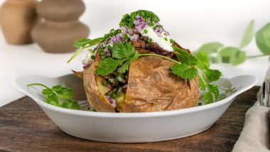Jacket potato with pulled brisket, sour cream and herbs