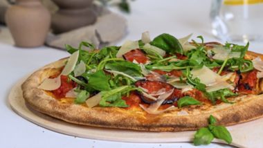 Diavola pizza with spicy salami, rocket and parmesan, served fresh onboard