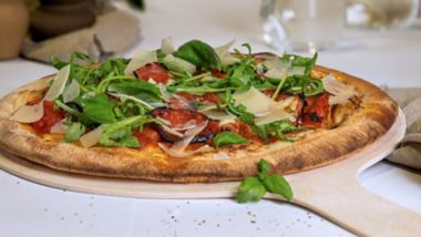 Diavola pizza with spicy salami, rocket and parmesan, served fresh onboard