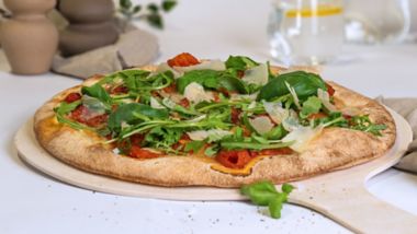 Vegetarian pizza with roasted vegetables, rocket and parmesan, baked fresh onboard