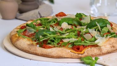 Vegetarian pizza with roasted vegetables, rocket and parmesan, baked fresh onboard