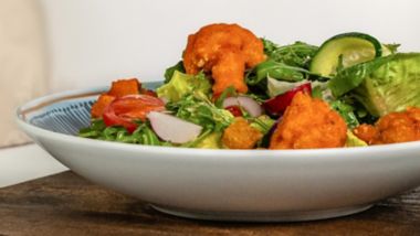 Vegan salad with crispy bites, fresh greens and cucumber