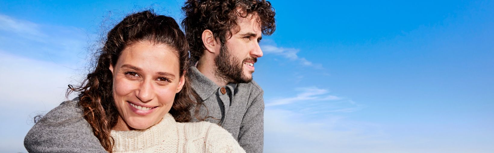 Couple embracing on outer deck of Stena Line ferry, enjoying sea views and fresh air on a relaxing ferry crossing
