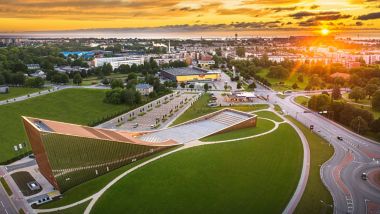 An aeriel view of Ventspils city in northwestern Latvia with the Baltic Sea in the background and the stunning VIZIUM Science Centre building in the foreground.