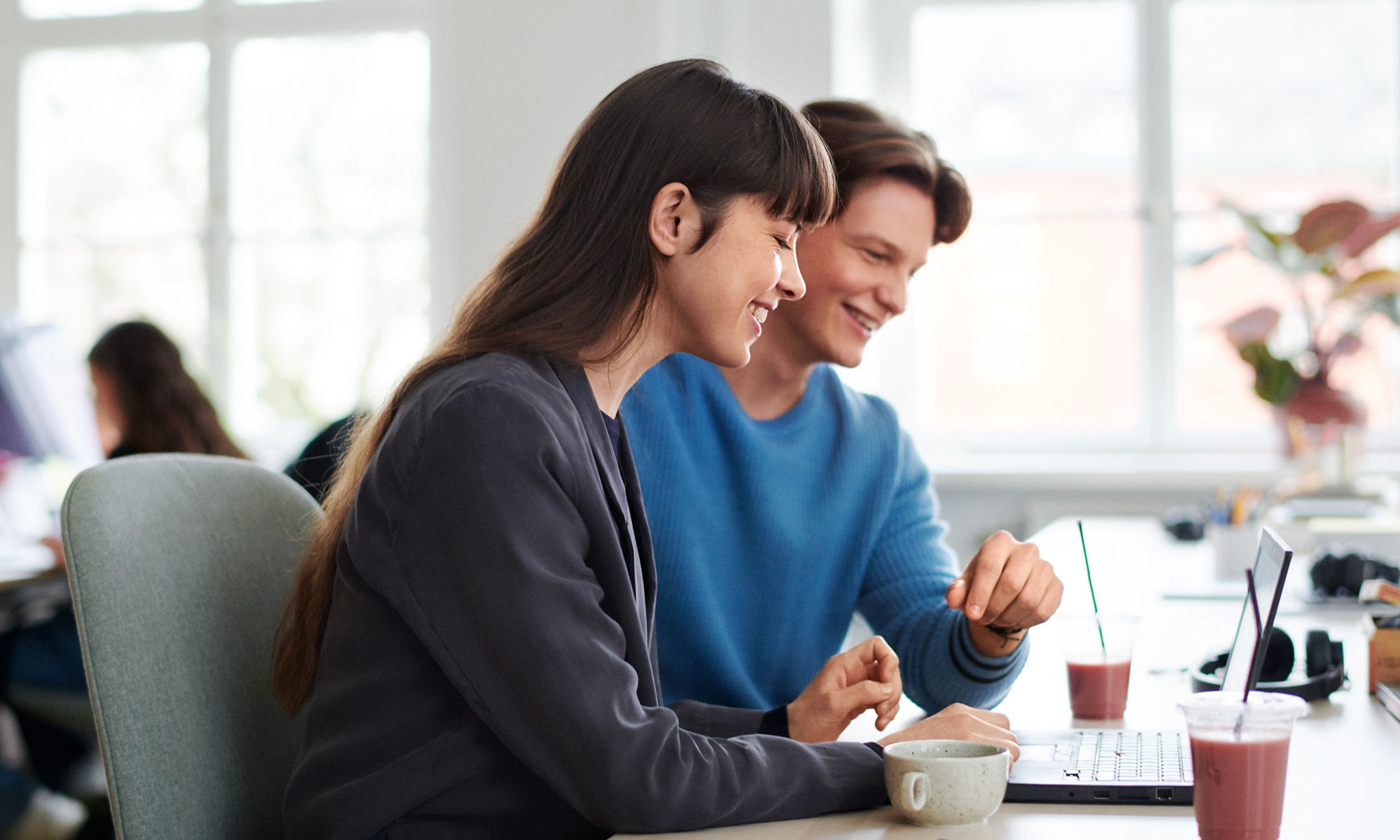 Woman and man at work by a laptop.