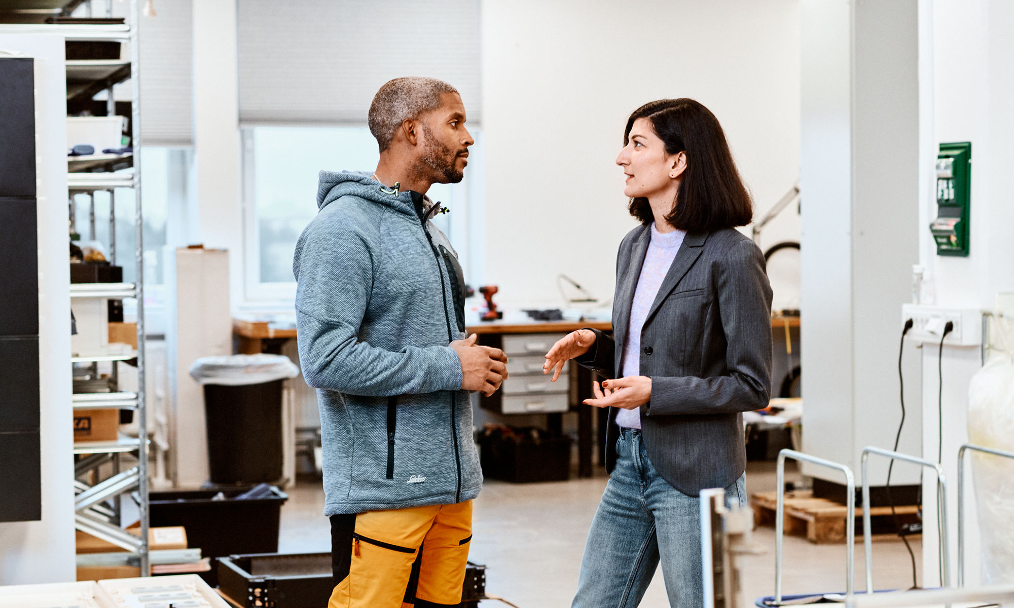 Man and woman in conversation at the workplace.