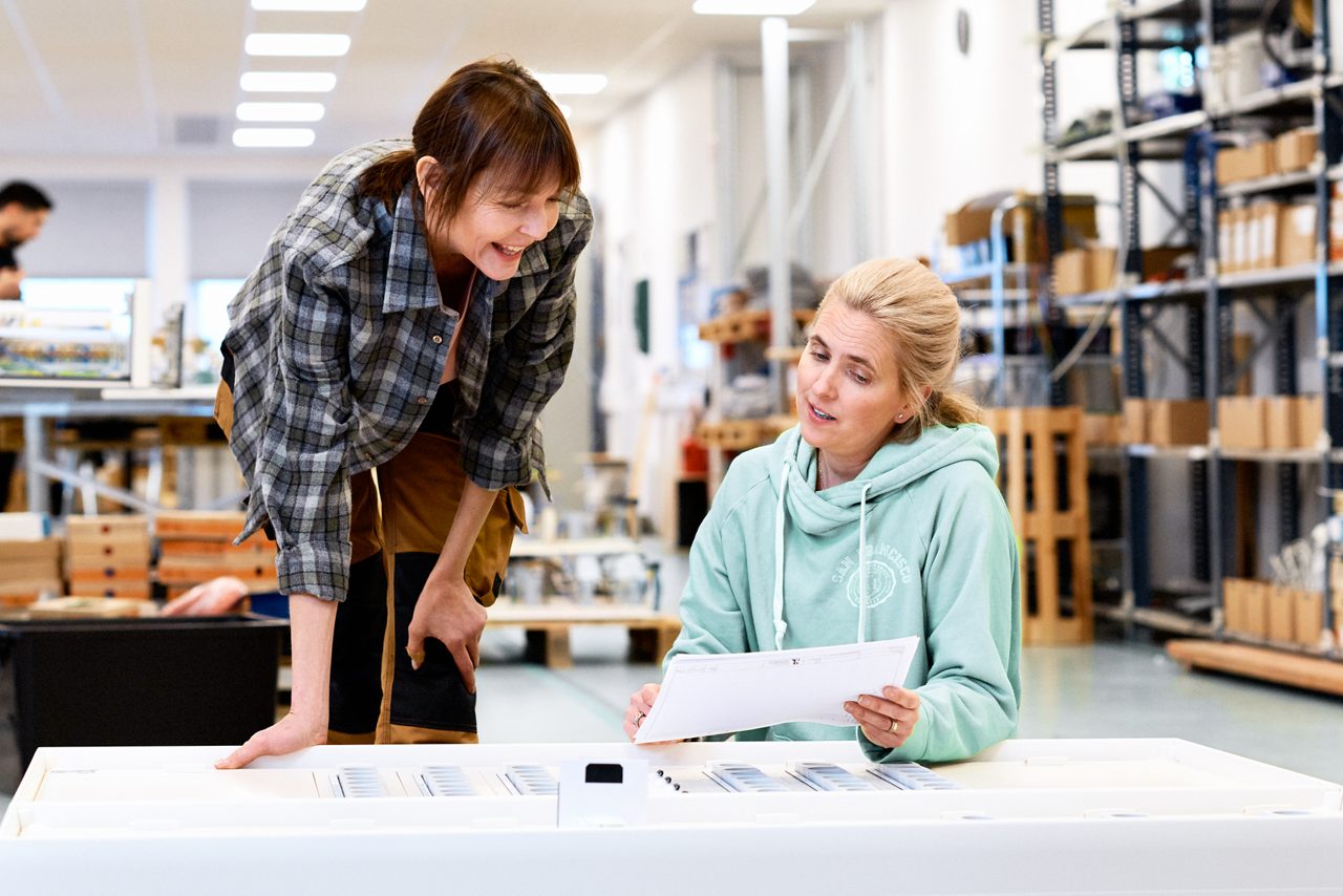 Two women in conversation at the workplace.
