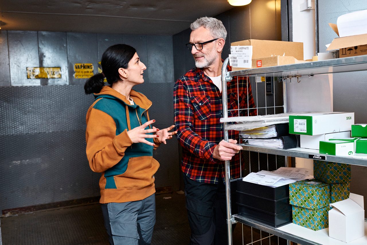 Man and woman in conversation at the workplace.