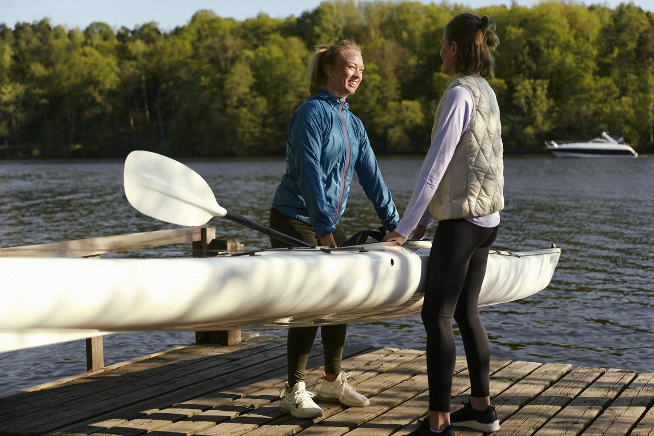 Två kvinnor bär en kajak