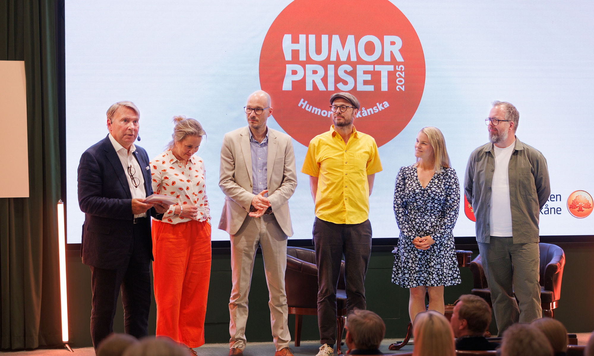 The jury of Humorpriset 2025 standing on a stage.