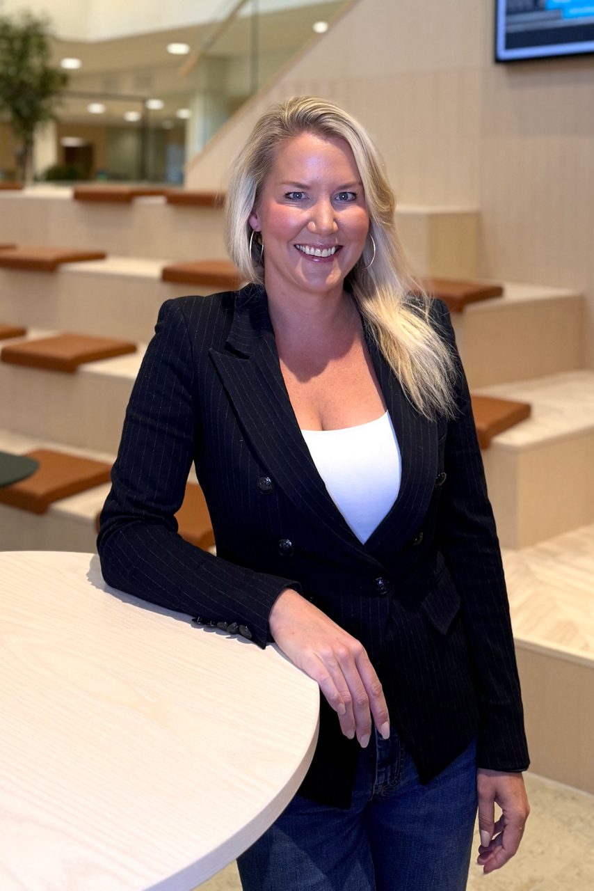 Kvinna tittar in i kameran och ler