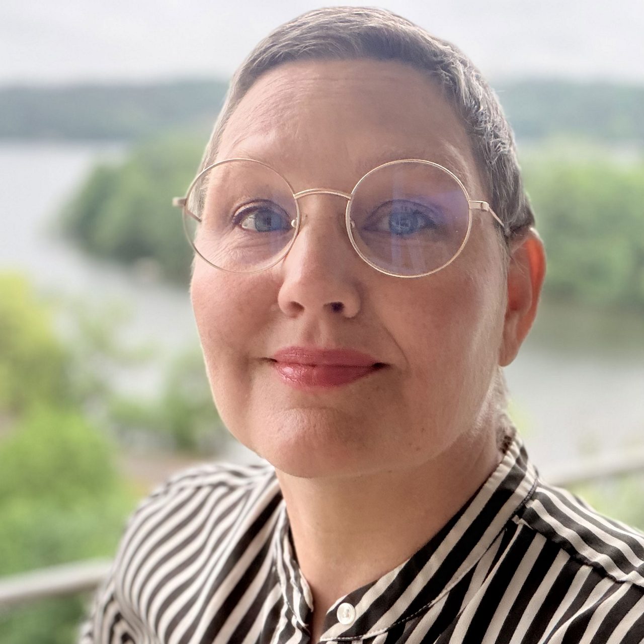 Smiling woman in striped shirt outdoors
