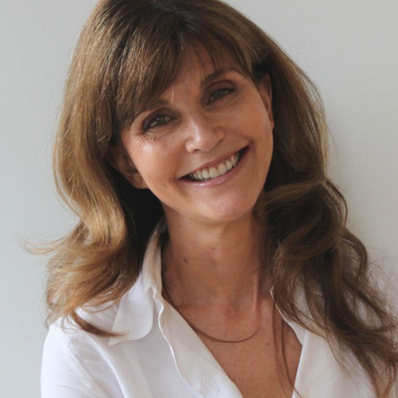 Anna Throne Holst Smiling woman in white shirt portrait