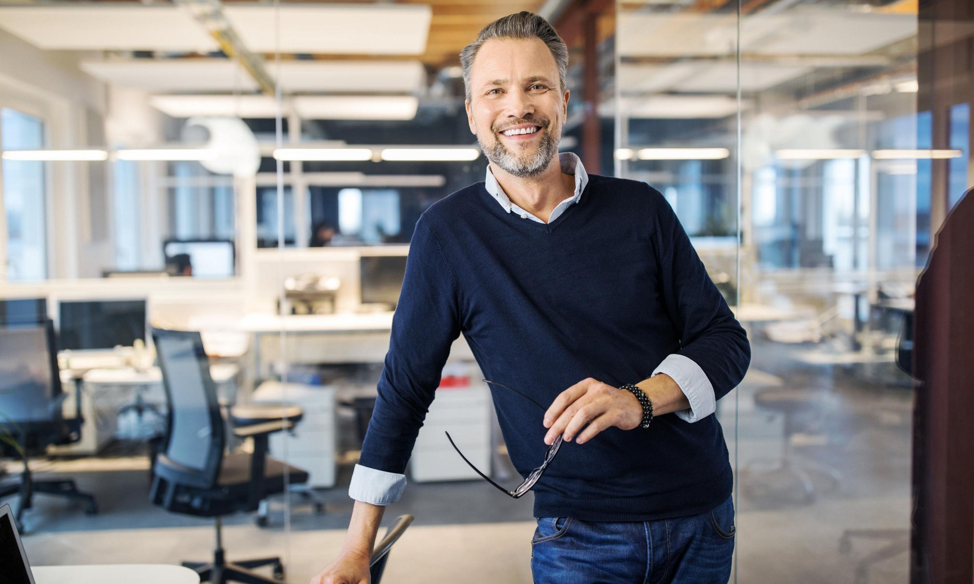 Mid adult businessman standing in office