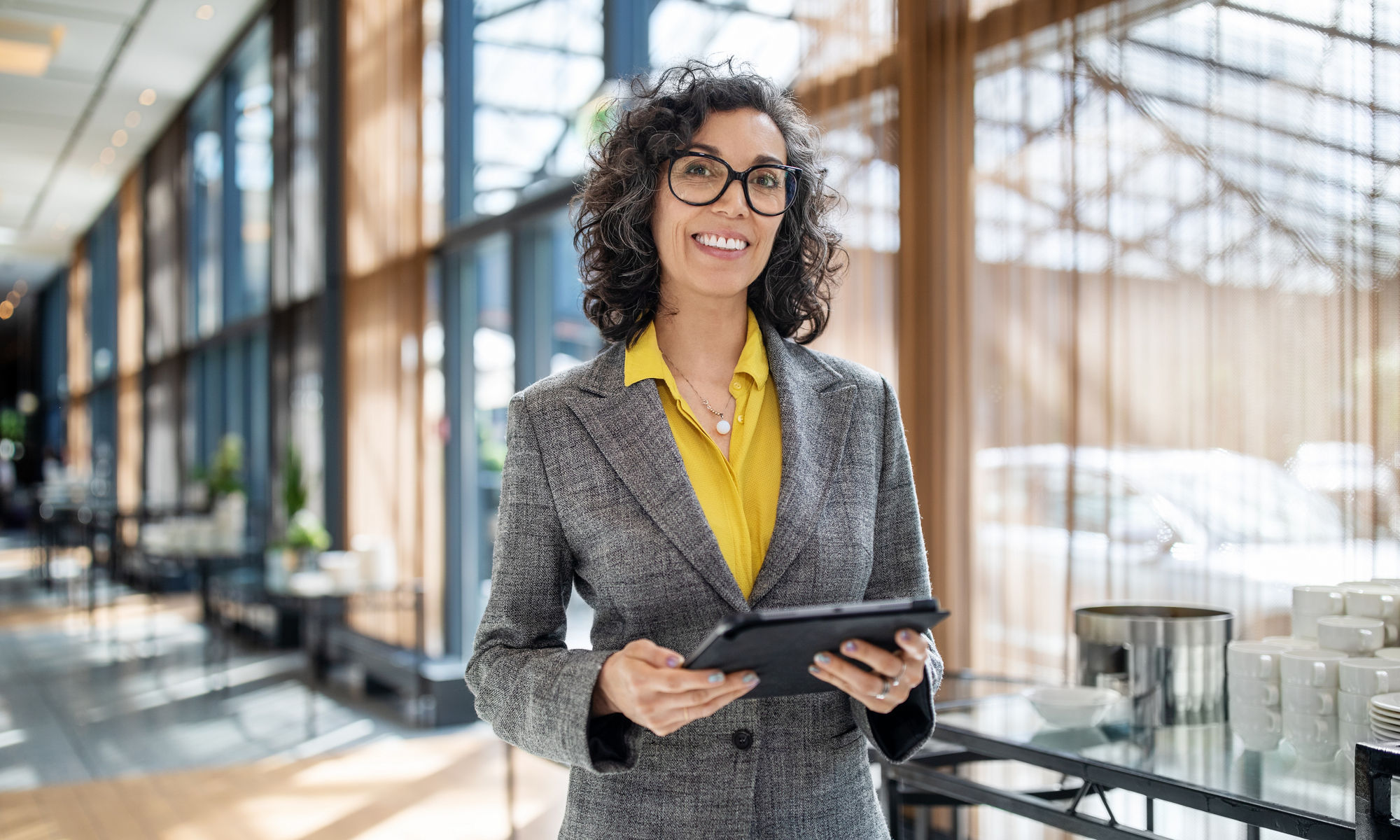 Senior businesswoman in corridor with digital tablet