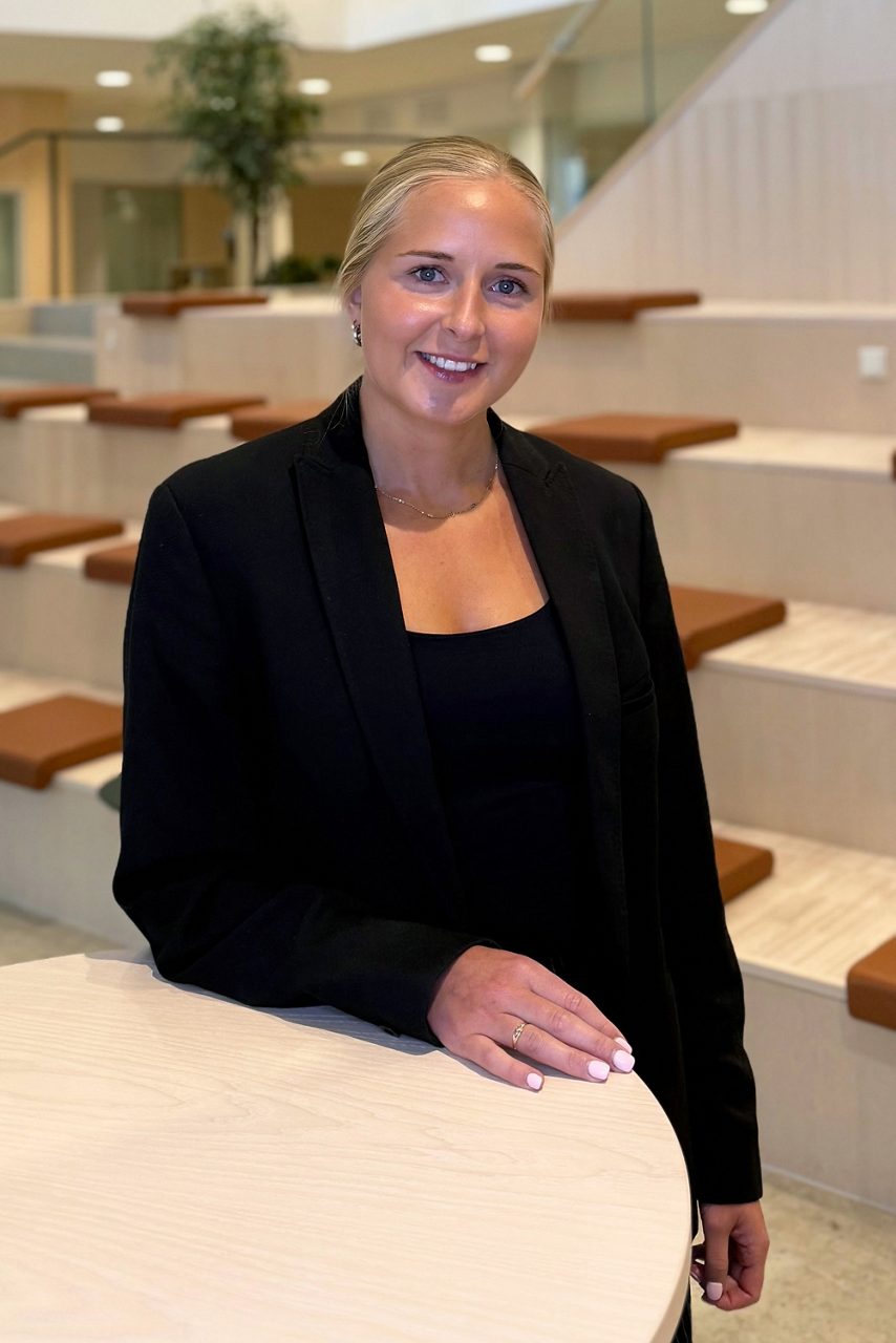 Kvinna tittar in i kameran och ler