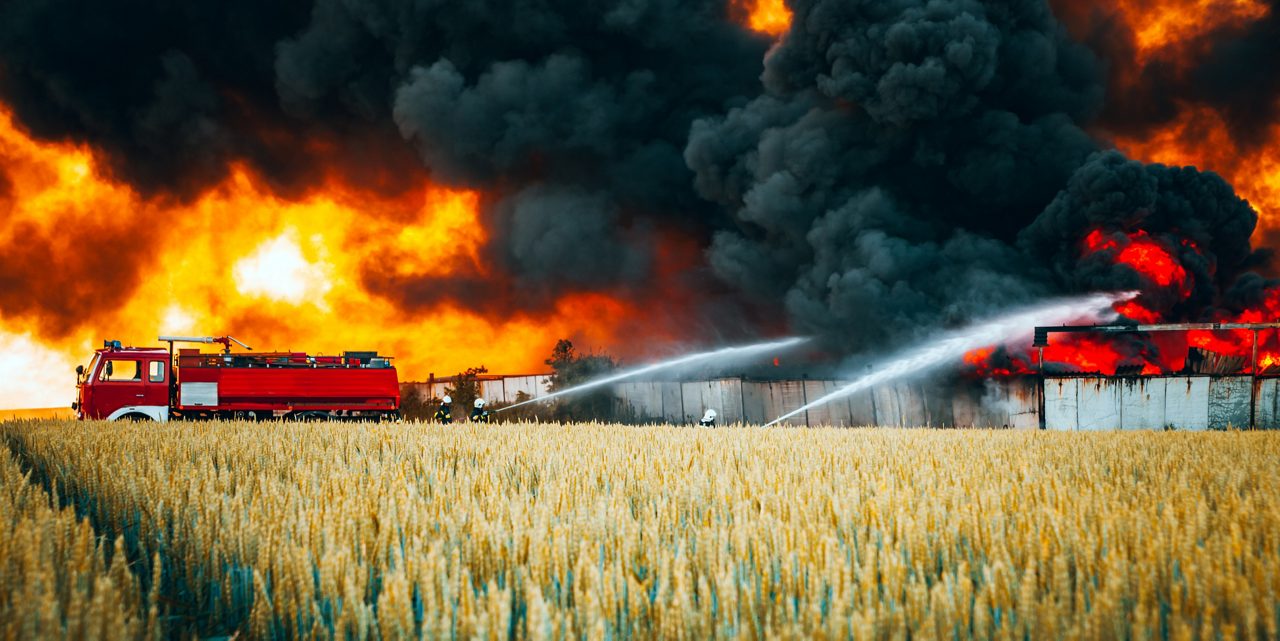 Fire department trying to take out fire on a field