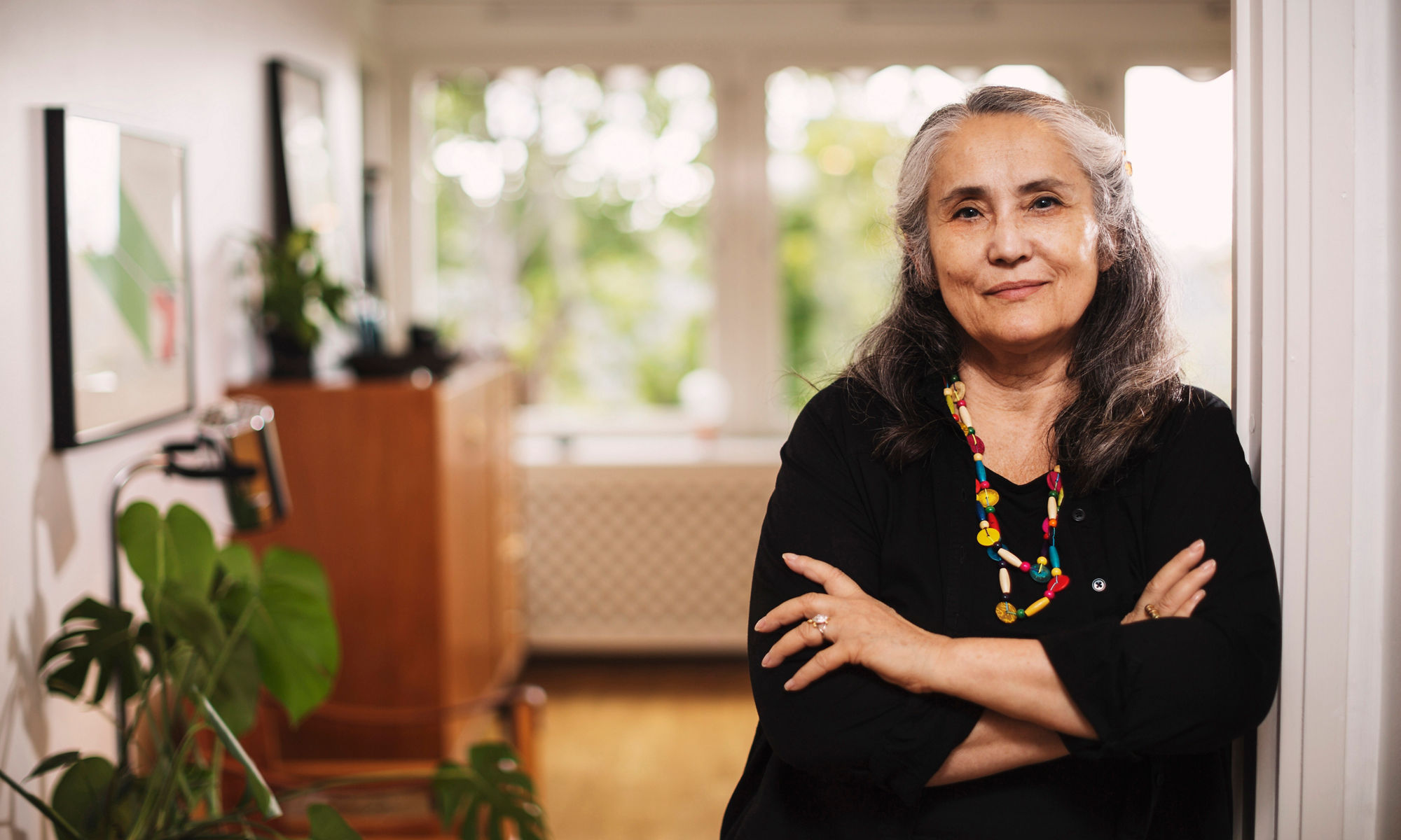 Confident - older woman leaning against doorpost