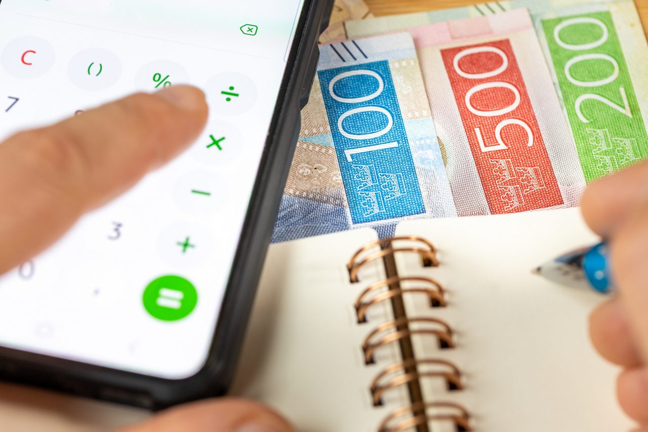 Money, note book, calculator on mobilphone