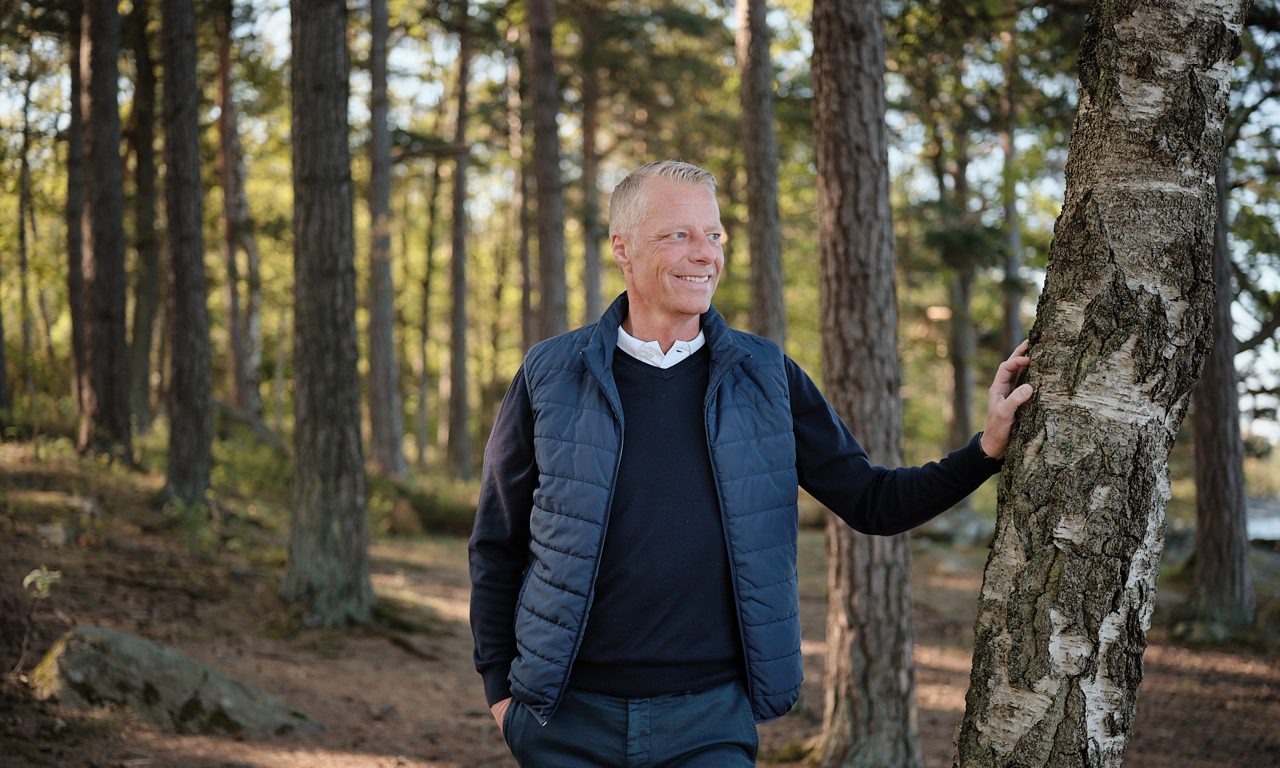 En man som lutar mot ett träd
