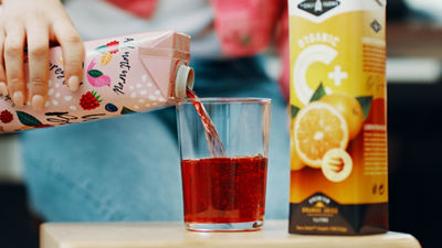 pouring juice from carton to glass