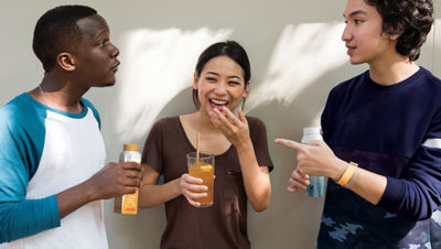 group of people holding beverages while talking