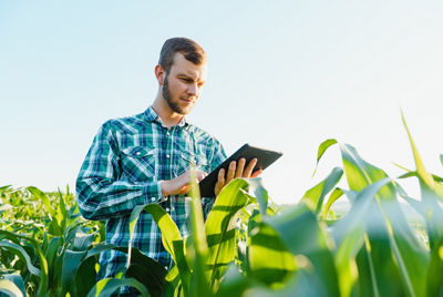 man in field with clipboard