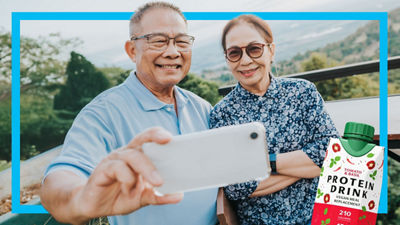 Elderly couple taking selfie, protein drink in Tetra Prisma Aseptic carton package