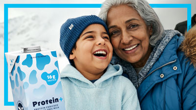 Woman with document holder, protein drink in Tetra Prisma Aseptic carton package