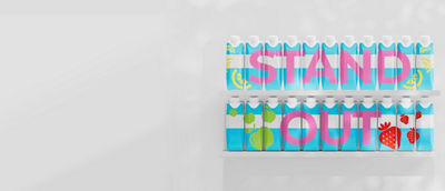 Tetra Prisma Aseptic packages spelling “STAND OUT” on a bright shelf display
