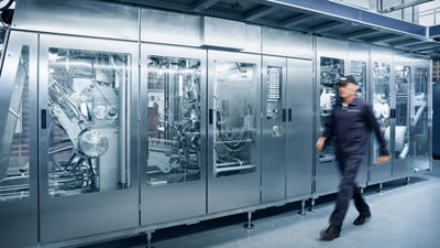 man walking next to machine