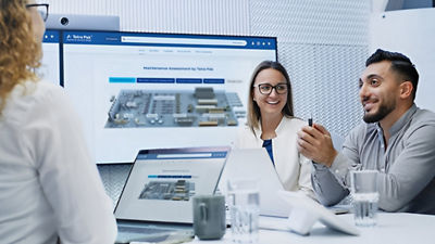 three people laughing with laptop