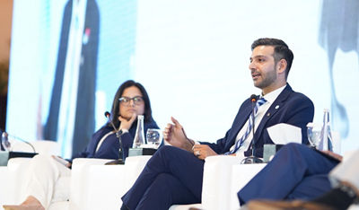 Two people sitting at a conference