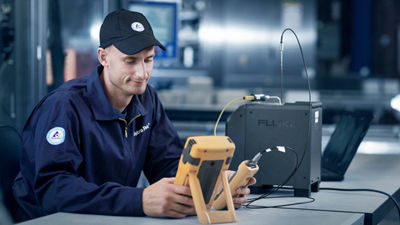 Service engineer with calibrating equipment