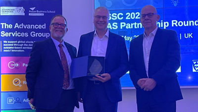 three people together with award