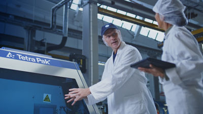 People in front of homogenizer