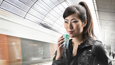 Woman on train station with Tetra Top carton