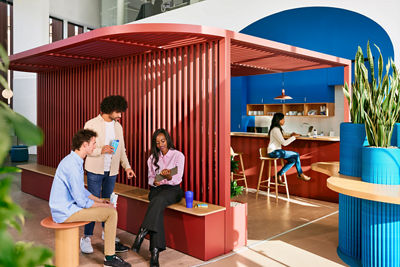 colleagues chatting in an open office vibrant environment