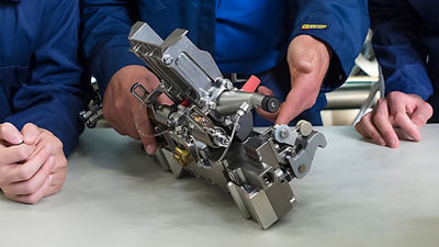 three people handling component