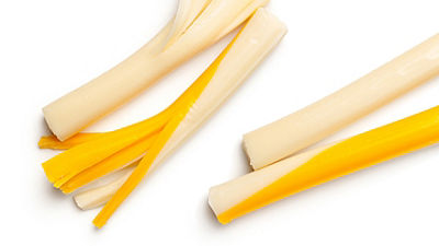 Four twisted  string cheese on a white bakground