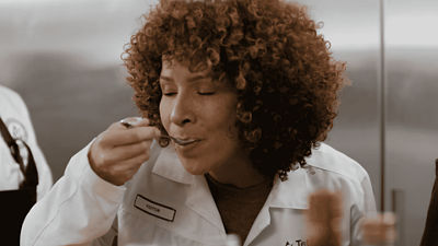 woman tastes a new creation from PDC