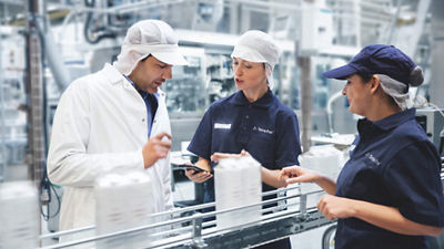 men in lab coat packaging machines