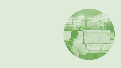 Operator looking at data on screens, green image