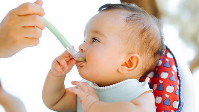Baby being feed with infant cereal