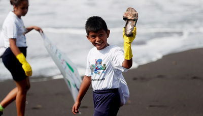 Boy cleaning beach in Guatemala