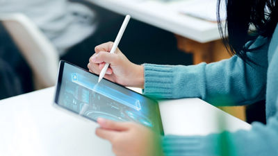 woman designing a beverage carton packaging on a tablet